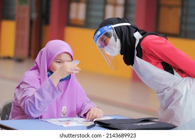 Muadzam Shah, Malaysia - April 7th, 2022 : Lateral-Flow-Test Covid Rapid Home-use Test Kit For Saliva - Step 2 - Spit With Mouth Through Funnel In Plastic Tube To Collect Sample.