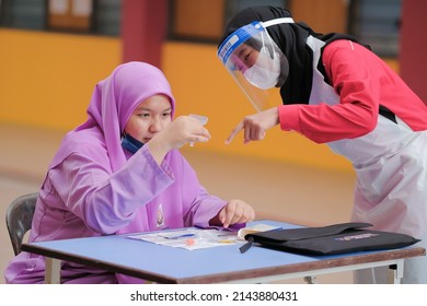 Muadzam Shah, Malaysia - April 7th, 2022 : Lateral-Flow-Test Covid Rapid Home-use Test Kit For Saliva - Step 2 - Spit With Mouth Through Funnel In Plastic Tube To Collect Sample.