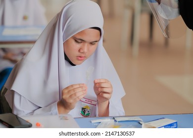 Muadzam Shah, Malaysia - April 7th, 2022 : Lateral-Flow-Test Covid Rapid Home-use Test Kit For Saliva - Step 2 - Spit With Mouth Through Funnel In Plastic Tube To Collect Sample.