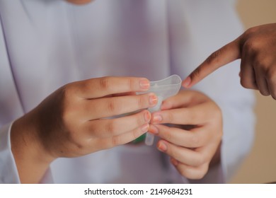 Muadzam Shah, Malaysia - April 7th, 2022 : Lateral-Flow-Test Covid Rapid Home-use Test Kit For Saliva - Step 2 - Spit With Mouth Through Funnel In Plastic Tube To Collect Sample.