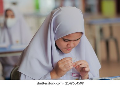 Muadzam Shah, Malaysia - April 7th, 2022 : Lateral-Flow-Test Covid Rapid Home-use Test Kit For Saliva - Step 2 - Spit With Mouth Through Funnel In Plastic Tube To Collect Sample.