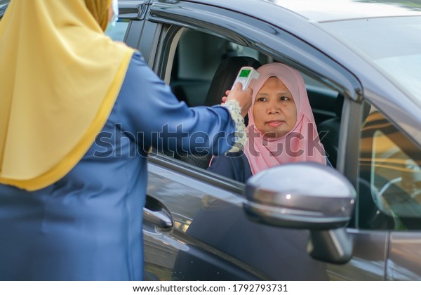 Muadzam Shah, Malaysia- August 4th, 2020 :\
Coronavirus check post on street car  staff checking body\
temperature corona virus covid-19\
epidemic.\

