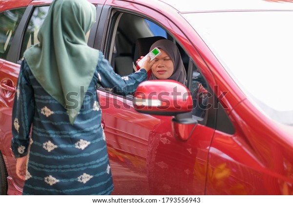 Muadzam Shah, Malaysia- August 4th,\
2020 : Coronavirus check post on street car  staff  checking body\
temperature corona virus covid-19\
epidemic.\
Keywords