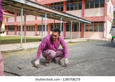 Muadzam Shah, Malaysia - January 3rd, 2019 : The Worker Clears The Clogged Sewer Drain Using Drain Clog Remover  To Remove The Dirt Attached To The Channel