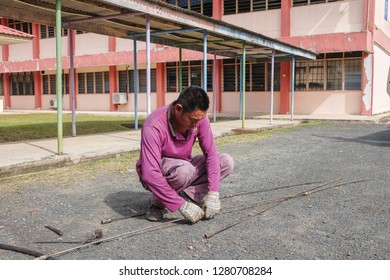 Muadzam Shah, Malaysia - January 3rd, 2019 : The Worker Clears The Clogged Sewer Drain Using Drain Clog Remover  To Remove The Dirt Attached To The Channel