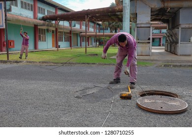 Muadzam Shah, Malaysia - January 3rd, 2019 : The Worker Clears The Clogged Sewer Drain Using Drain Clog Remover