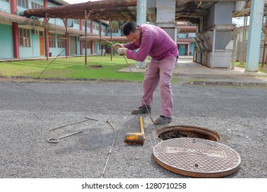 Muadzam Shah, Malaysia - January 3rd, 2019 : The Worker Clears The Clogged Sewer Drain Using Drain Clog Remover