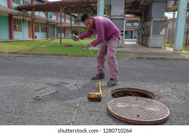 Muadzam Shah, Malaysia - January 3rd, 2019 : The Worker Clears The Clogged Sewer Drain Using Drain Clog Remover