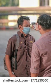 Muadzam Shah, Malaysia - July 7th, 2020 : Teacher Using Thermometer Temperature Screening Student For Fever Against The Spread Of COVID-19 While Student Coming Back To School, Education Concept.