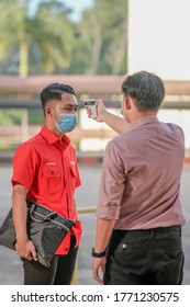 Muadzam Shah, Malaysia - July 7th, 2020 : Teacher Using Thermometer Temperature Screening Student For Fever Against The Spread Of COVID-19 While Student Coming Back To School, Education Concept.