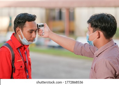 Muadzam Shah, Malaysia - July 7th, 2020 : Teacher Using Thermometer Temperature Screening Student For Fever Against The Spread Of COVID-19 While Student Coming Back To School, Education Concept.