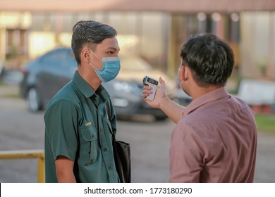 Muadzam Shah, Malaysia - July 7th, 2020 : Teacher Using Thermometer Temperature Screening Student For Fever Against The Spread Of COVID-19 While Student Coming Back To School, Education Concept.