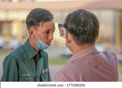 Muadzam Shah, Malaysia - July 7th, 2020 : Teacher Using Thermometer Temperature Screening Student For Fever Against The Spread Of COVID-19 While Student Coming Back To School, Education Concept.