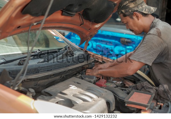 Muadzam\
Shah, Malaysia - June 1st,  2019:  Mechanic  holding dirty air\
filter for car, maintenance and repair\
concept