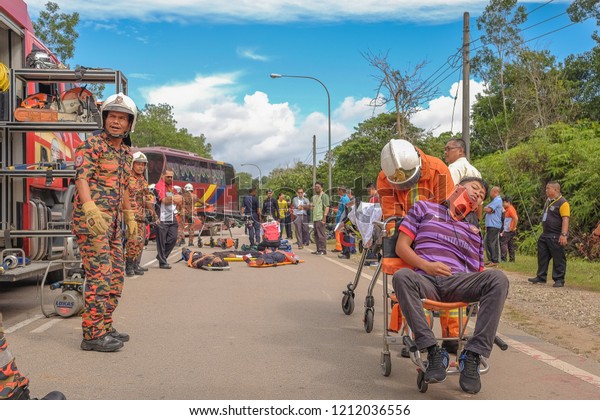 Muadzam Shah, Malaysia - October 18th, 2018 :\
Firefighter  and air force rescuing wounded young man in accident\
between car, bike and bus in Inter Agency Disaster Training Program\
2018 at Muadzam Shah
