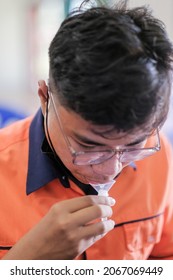 Muadzam Shah, Malaysia - October 31th, 2021 : Lateral-Flow-Test Covid Rapid Home-use Test Kit For Saliva - Step 2 - Spit With Mouth Through Funnel In Plastic Tube To Collect Sample.