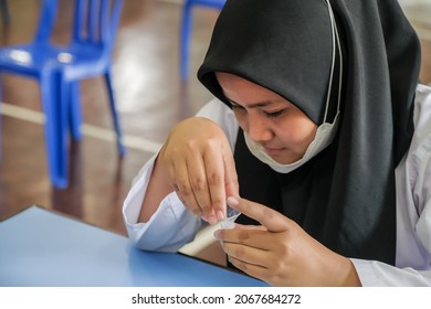 Muadzam Shah, Malaysia - October 31th, 2021 : Lateral-Flow-Test Covid Rapid Home-use Test Kit For Saliva - Step 2 - Spit With Mouth Through Funnel In Plastic Tube To Collect Sample.