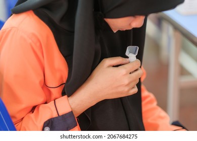 Muadzam Shah, Malaysia - October 31th, 2021 : Lateral-Flow-Test Covid Rapid Home-use Test Kit For Saliva - Step 2 - Spit With Mouth Through Funnel In Plastic Tube To Collect Sample.