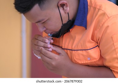 Muadzam Shah, Malaysia - October 31th, 2021 : Lateral-Flow-Test Covid Rapid Home-use Test Kit For Saliva - Step 2 - Spit With Mouth Through Funnel In Plastic Tube To Collect Sample.