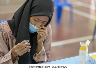 Muadzam Shah, Malaysia - October 31th, 2021 : Lateral-Flow-Test Covid Rapid Home-use Test Kit For Saliva - Step 2 - Spit With Mouth Through Funnel In Plastic Tube To Collect Sample.