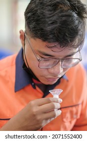 Muadzam Shah, Malaysia - October 31th, 2021 : Lateral-Flow-Test Covid Rapid Home-use Test Kit For Saliva - Step 2 - Spit With Mouth Through Funnel In Plastic Tube To Collect Sample.