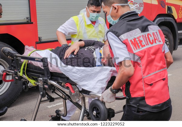 Muadzam Shah,\
Pahang - October 18th, 2018 :Rescuers are helping the wounded on a\
stretcher to an ambulance during road accidents in  Inter Agency\
Disaster Training Program 2018\
.