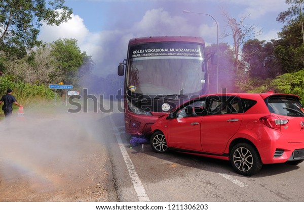 Muadzam Shah,Pahang-October 18th, 2018 :Fireman\
using water and extinguisher to fighting with fire flame in an\
emergency situation during road accidents in  Inter Agency Disaster\
Training Program 2018