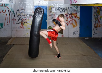 A Muay Thai Fighter Giving A Knee Kick During A Practice