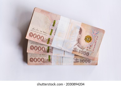 Much Banknote of One Thousand Thai Baht on coins. Thai currency, medium of exchange, and stock market concept .