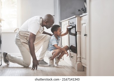 Its so much fun to mix all the ingredients. Shot of a father and son standing by the oven in the kitchen. - Powered by Shutterstock