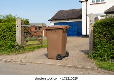 Much Hadham, Hertfordshire. April 16th 2020. Single Brown Wheelie Bin Containing Garden Waste Outside A House Ready To Be Emptied By Refuse Collectors.