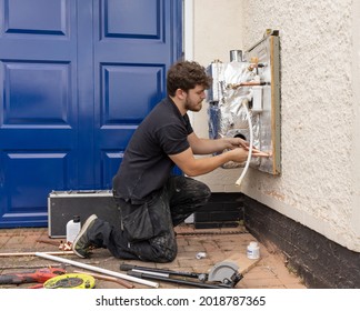 Much Hadham, Hertfordshire, UK. August 3rd 2021. Boiler Installation Engineer Installing A New Domestic Outdoor Oil Fired Boiler.