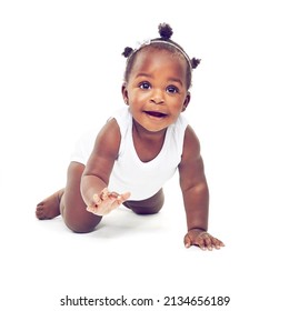 So much to see.... Studio shot of a baby girl crawling against a white background. - Shutterstock ID 2134656189