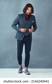 So much style. Studio shot of a handsome and dapper young man posing against a grey background.
