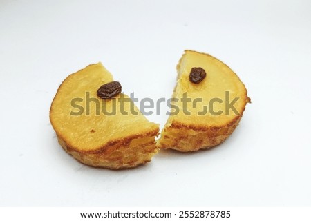 mud cake split in half. or mud cake is a traditional Indonesian cake, made from potatoes, flour, eggs, fresh milk with raisin topping on top. the taste is sweet and the texture is soft.
