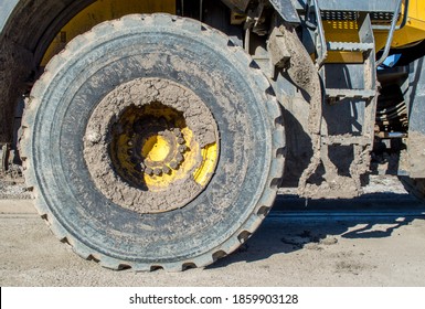 Mud Caked Steps And Heavy Duty Tire On A Bulldozer