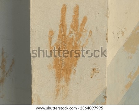 Mud Hand Print on white  Wall. dirty hand print. mud with hand print shape pattern. Close up human hand print on the wall