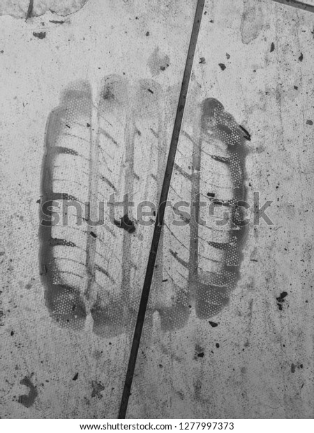 Mud mark of a car tire. Tire brand. Black and white\
photo 