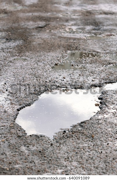 Mud and puddle or pit on\
the road