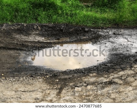 mud puddles on potholed roads