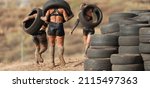 Mud race runners. Runners carrying tires in a test of the race