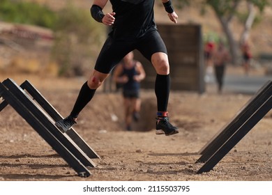 Mud race runners during extreme obstacle race - Powered by Shutterstock