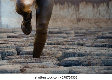 Mud race runners, tries to make it through the tire trap - Powered by Shutterstock