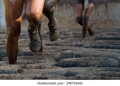 Mud race runners, tries to make it through the tire trap