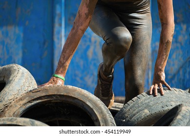 Mud race runners, tries to make it through the tire trap - Powered by Shutterstock