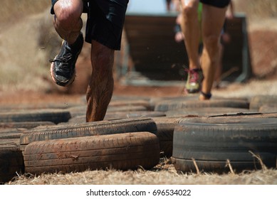 Mud race runners, tries to make it through the tire trap