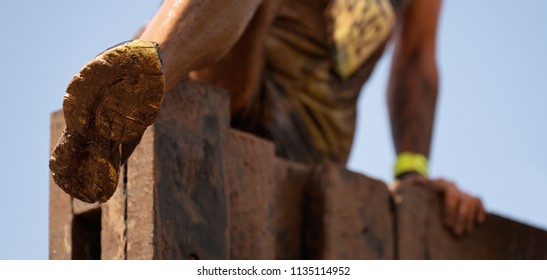 Mud race runners view of the participant for overcoming hurdles - Powered by Shutterstock