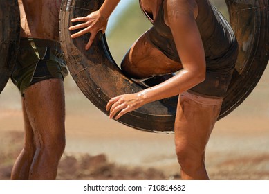 Mud race runners i will overcome the obstacle from hanging tires - Powered by Shutterstock