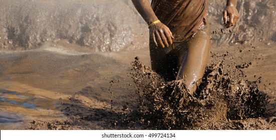 Mud race runners,man running in mud - Powered by Shutterstock