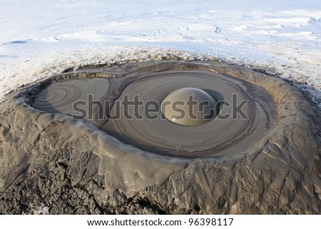 a mud volcano crater in winter. Buzau, Romania